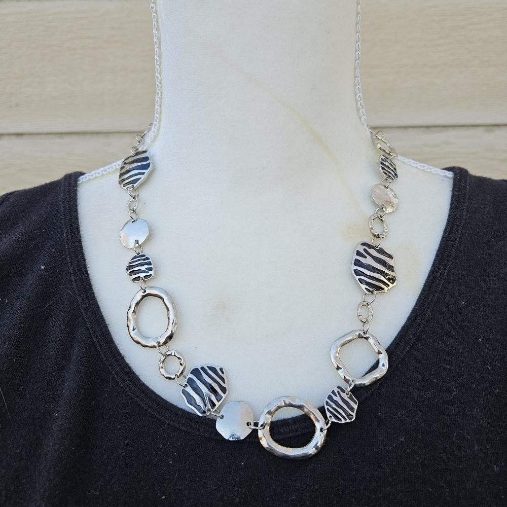 silver tone necklace with open links and zebra stripes